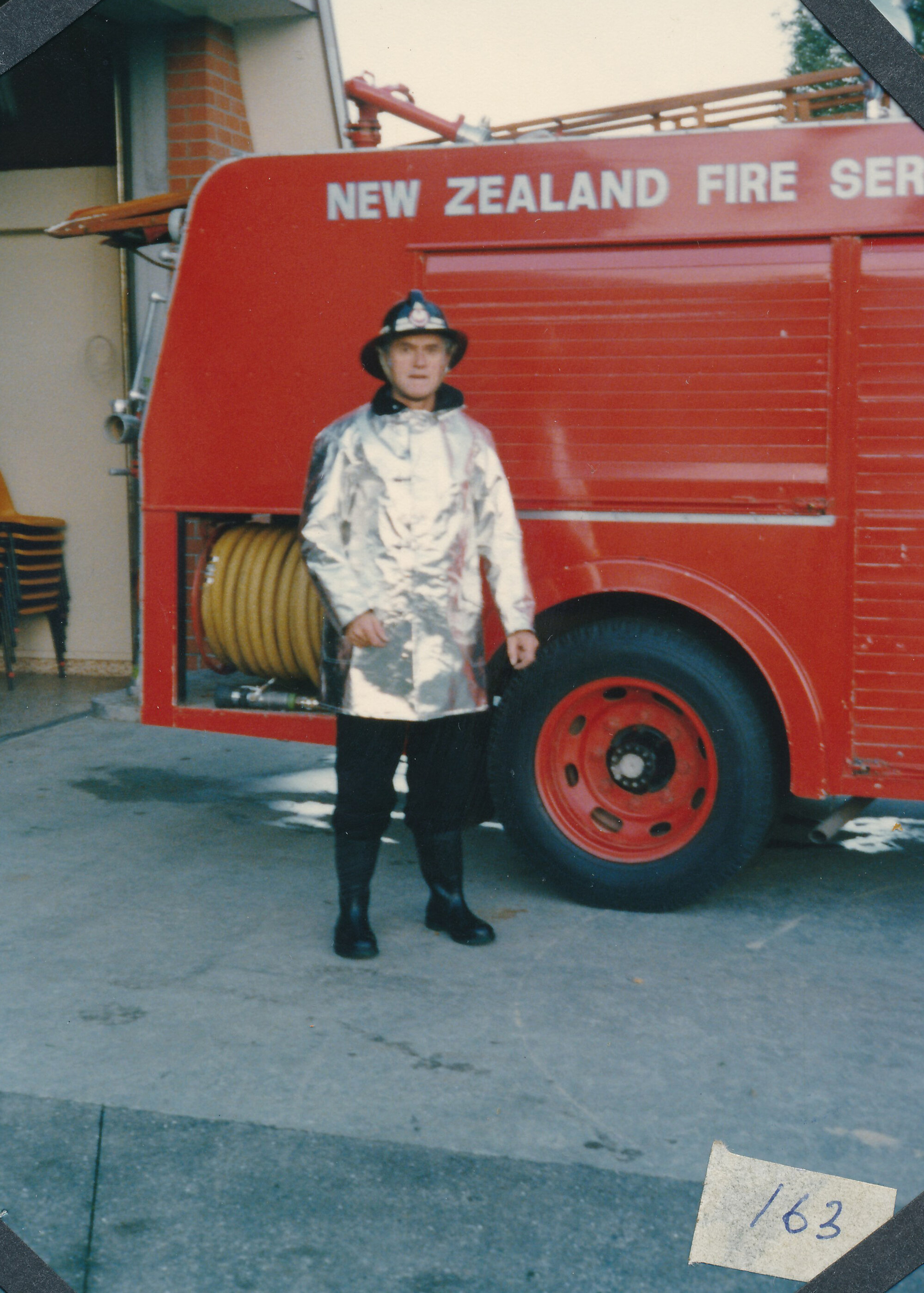Silverstream Volunteer Fire Brigade; Firefighter in new silver gear, with fire engine