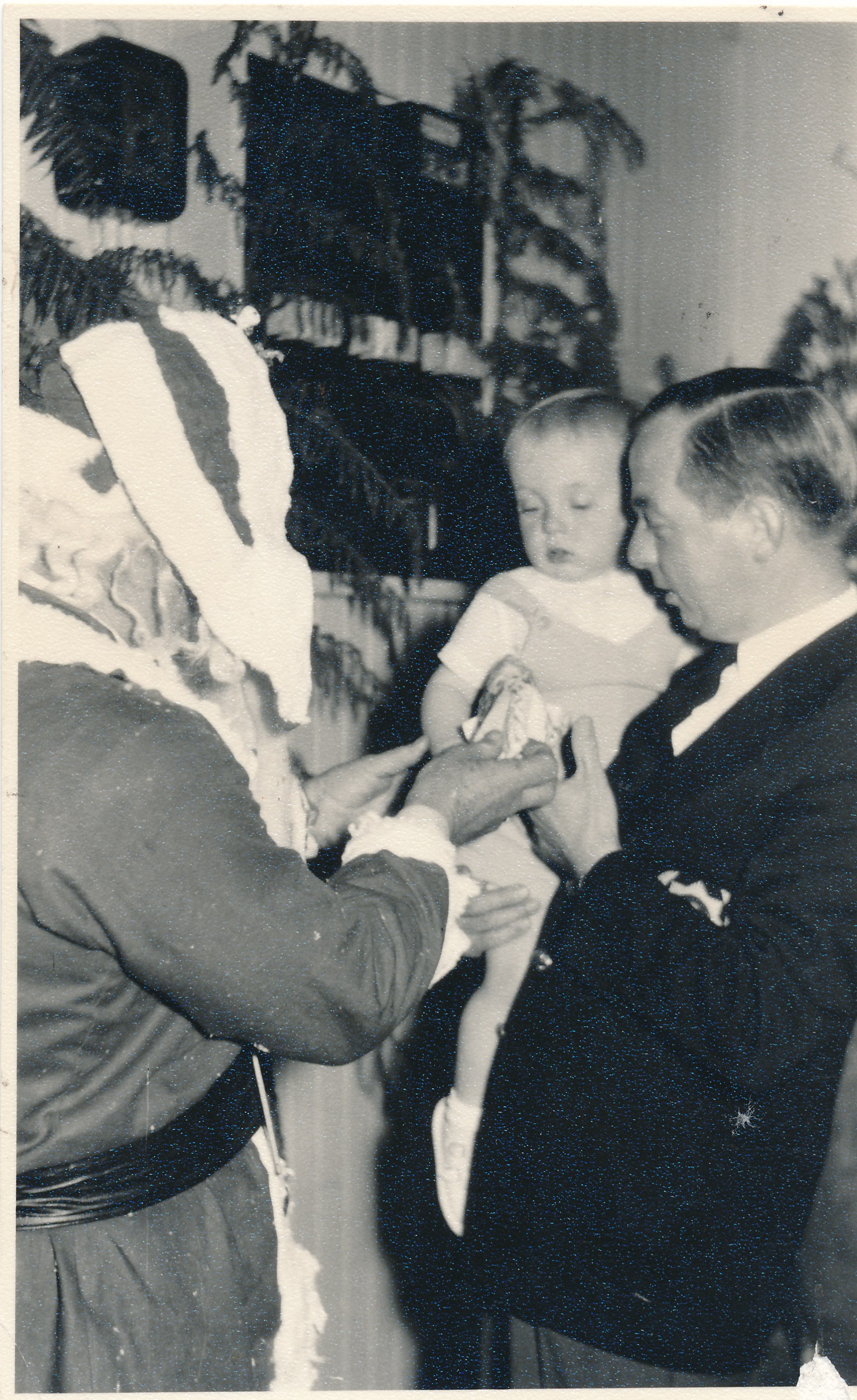 Silverstream Volunteer Fire Brigade; Christmas; Len Rink (Santa) giving Grant Hamilton a present; 1958