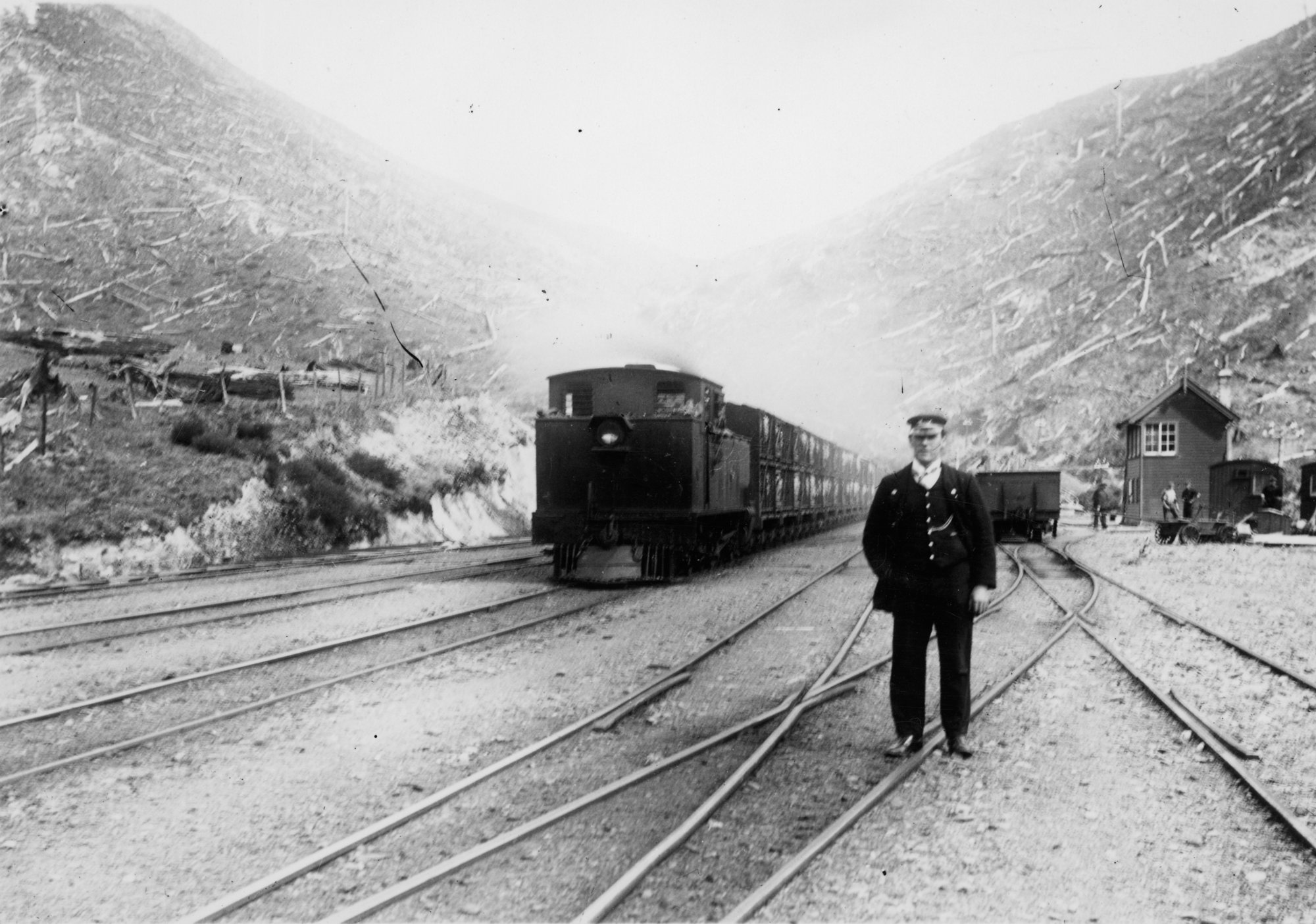 Summit station; southbound stock train about to leave; guard in foreground.