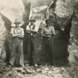Birchville water-supply dam 2; construction, 1930. Three men in rock excavation.