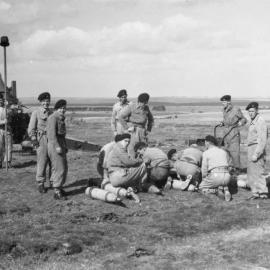 M115 8-inch howitzer 3; gun crew preparing shell for firing. [P1-379-1839]