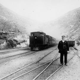 Summit station; southbound stock train about to leave; guard in foreground.