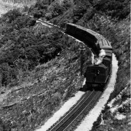 Rimutaka Incline; two Fell locomotives descending with passenger train. [P2-20-28]