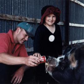 Blair Griffiths, of Katherine Mansfield Drive, with Coke-guzzling pig Suzie, and  Kadeen Williams.