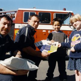 Brentwood School; firefighters Greg McLean, Tony Gibbs give Seth Nghere-Ryan and Zara King Kidsafe Week material.
