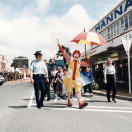 School crossing children's parade 1996 in Main Street, with 'Ronald McDonald'; Constable Mark Fink, 'Ronald McDonald', Bronwyn Lord leading.