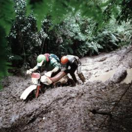 Trail bike riders Mark Stewart, Steve Purchase on (or in) a track at Karapoti called "the bog".