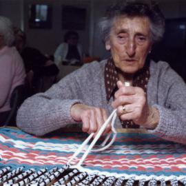 Braille week; Minnie Smith making a bathmat completely by touch.