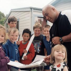 Maoribank School; Wellington Hurricanes rugby player Mike Edwards signs a poster.