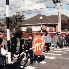 Oxford Crescent School; Year 5 and 6 pupils teaching younger ones road safety on pedestrian crossing.