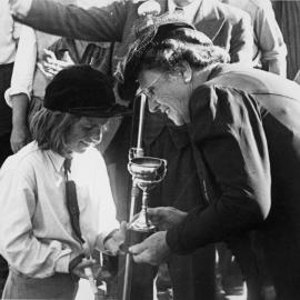 A & P show; young riding competitor receiving cup.