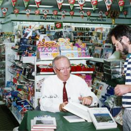 London Bookshop; author Jack Kelleher signing histories. [P2-639-1557]