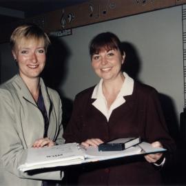 Teachers Tracey McLennan and Ellie Watts with video and proof of their book 'The Melting Pot'.