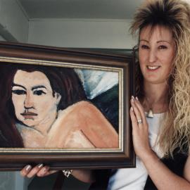 Archibald's Gallery; Mary Archibald's daughter Loren Foster with acrylic painting by Marianne Linton.