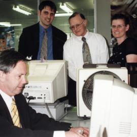 Library; Paul Swain, Minister of Information Technology, at a public-use computer terminal.