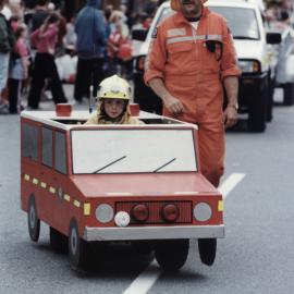 Christmas parade 2003; small fire engine and fireman, with Dad; unnamed.