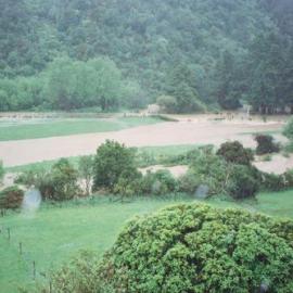 Flood, Karapoti; water crossing the road in the background.