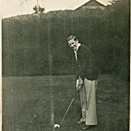 Man with golf club, 1930s