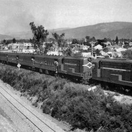 Railway locomotives; De-class diesel-electrics and passenger train leaving Upper Hutt for the Wairarapa.