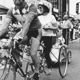Christmas parade 1987; David Butler and Sheila Radcliffe on tandem tricycle with son Chase in trailer.