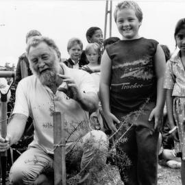 English botanist Dr. David Bellamy plants a tōtara tree at Upper Hutt Primary School; 1989