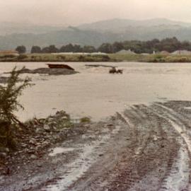 Totara Park bridge site; river in flood.