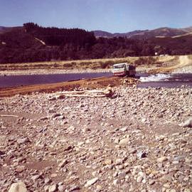 Totara Park; Truck bringing concrete pipesacross the river.