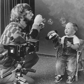 Andrew Chaplow  photographing Hamish Cain, 2, for a Plunket infant photo competition.
