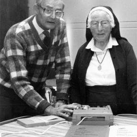 Home of Compassion;  Blind Foundation's Peter Nash explains a 'talking book' to Sister Eustace.