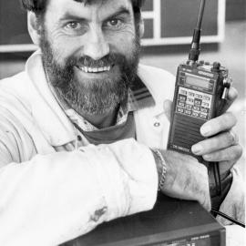 John MacDonald with hand-held and desk-top transmitter/receivers.