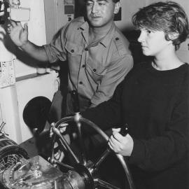 Navy; Sea Cadet Alison Rodgers at the wheel of frigate HMNZS Southland, with Able Seaman Barry Waerea.