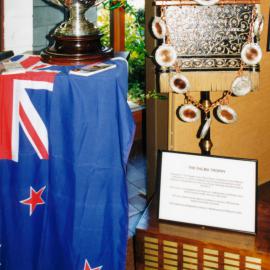 Rifle shooting; Bisley Cup and Palma Trophy displayed in the public library.