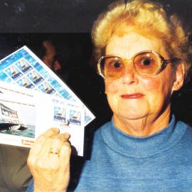 America's Cup stamps on sale; Doris Scarlett with first-day covers and 10-stamp 'sheetlet'