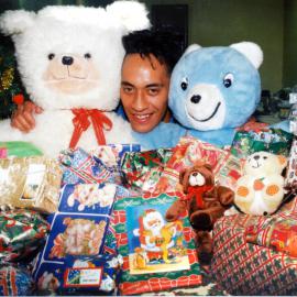 Upper Hutt Leader staff; Mathew Tomokino with toys from annual appeal.