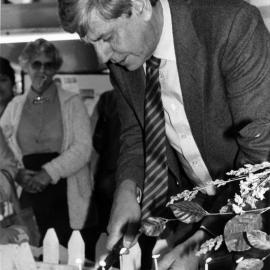 Maidstone Mall; promotions manager Murray Hunt cuts one of three fourteenth-birthday cakes.