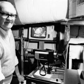 Fred Charles, former gas engineer and Energy Board member, transferring films to video-tape.