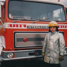 Silverstream Volunteer Fire Brigade; Firefighter Tim Rees in fire fighting gear with 'International' fire engine; circa 1990s