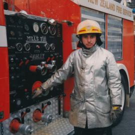 Silverstream Volunteer Fire Brigade; Firefighter Tim Rees standing next to a 1990s pump operators station