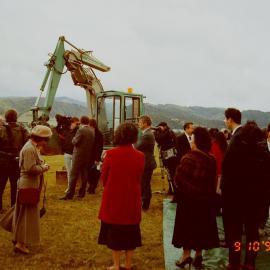Craig's Flat ground-breaking; crowd and excavator