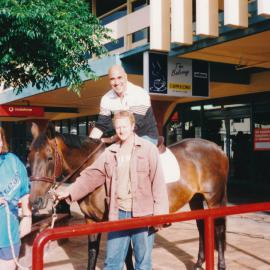 Nick Tansley and Frankie Stevens on a horse; Main Street; ca 2000s