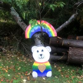 Teddy Bear and rainbow sign beside a street in Pinehaven