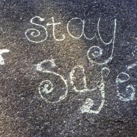 "Stay Safe" message painted on pavement, Pinehaven