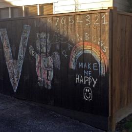 Child's chalk drawings on fence, Heretaunga 