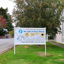 Covid-19 posters on Our Lady of Grace Church sign, Heretaunga