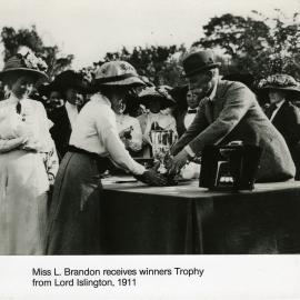 Trentham racecourse; Miss L. Brandon receives winner's trophy from the Governor-General, Lord Islington. [P3-554-3278]