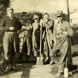 Men Standing on Footpath; ca 1940s
