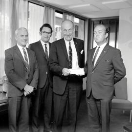 Hedley Gibson (BNZ manager) presents cheque to mayor George Thomas.