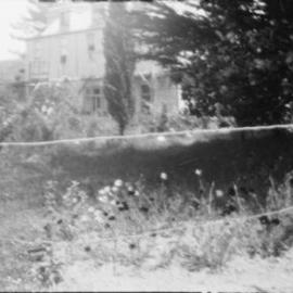 McCurdy's Castle with flower garden in foreground.